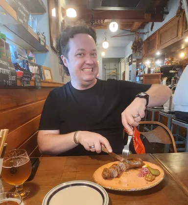 Levi eating sausages at Barchies in Kamakura